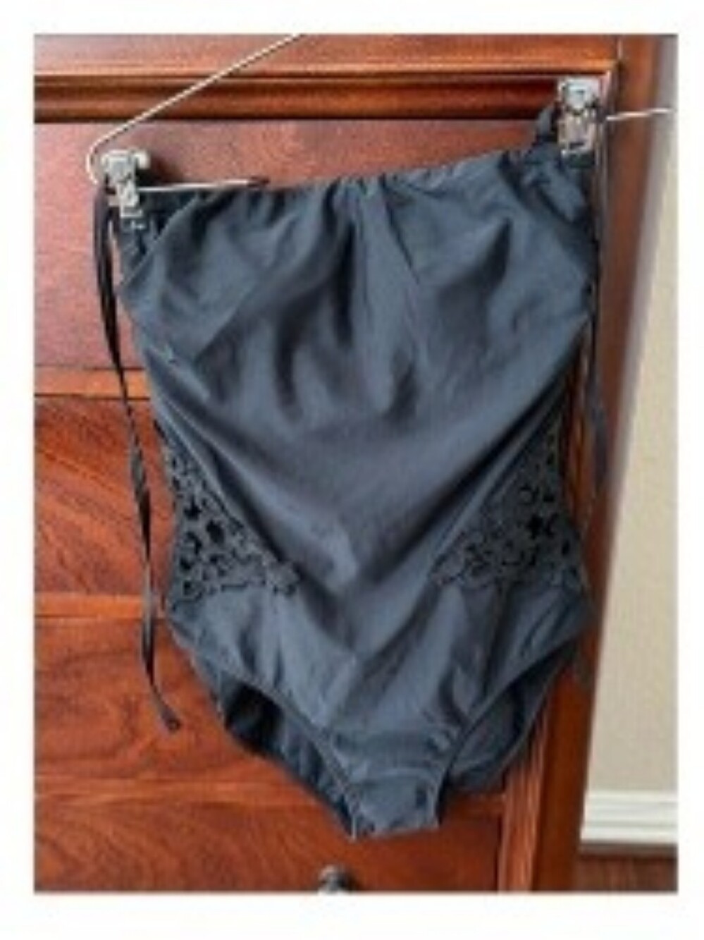 Venus black one piece swim suit with sexy cut-outs.  No straps.